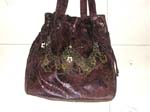 Women's brown leather handbags with multi chain holding copper flower shape chips design