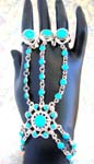 Jewelry fashion wholesale shopping online. fashionable slave bracelet with turquoise colored gems inlaid throughout. Silver plated chain extends from bracelet to three stoned rings