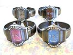 Jewelry fashion catalog at wholesale price. Womens fashion cz gemstone watch in large oval shape design, colored clock face, and bangle bracelet