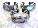 Fine fashion accessory supply import B2B company. Artist inspired bangle bracelet watch with cz gemstones inlaid in abstract designed frame inlaid with rhinestones 