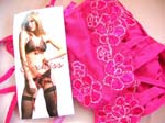 Best wholesale import distributor sells Quality pink lingerie set with decorative stitching in flower design on bra, panties, and garter belt from China