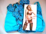 Sex Kiss apparel sold at wholesale price from import supplier. Baby blue lingerie set in satin style fabric with embroidered floral designs on bra, panties, and garter belt