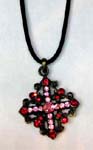 Womens accessory wholesale store distributes rhinestone jewelry. Diamond shaped pendant with pink cz stoned cross at center and red crystals framing