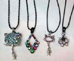 Pendant, necklace accessory outley distributes China import jewelry. Fun cubic zirconia pendants in an assortment of designs hanging from black beaded necklace