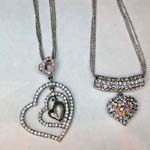 Hip hop fashion jewelry wholesaler distributes fine cz pendants. Imitation diamond pendant necklaces in heart shaped designs hanging from silver plated, beaded necklace 
