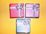Designer beauty jewelry box cases distributed wholesale to retail shops. Gift theme jewelry box with colored wrapping and silver bows.