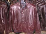 Motorcylce jacket warehouse imports mens wear fashions. Mens motorcycle jacket made from maroon imitation leather that has elastic waist and cords to cinch up collar