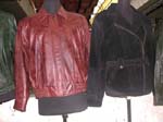 Buy Womens imitation leather jacket from China outsourcing manufacturing company. Jacket in maroon color with black designs. Elastic waist cuts off at hip level and has a bottom up flap to cover zipper