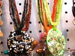 Crafted seashell jewelry supplied by online international gift wholesaler. Colored shell necklaces with multiple beaded strings and large oval shaped pendant