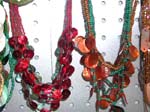 Summer craft necklace supply company imports wholesale manufactuered products. Beaded necklace with multiple circle shells attached to bottom half of necklace