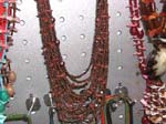 Beach wear accessory supply distributor selling necklace at discount cost. Multi stringed, beaded necklace with brown stones interspersed throughout