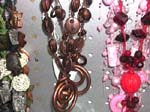 Necklace bead jewelry online wholesale store distributes seashell necklaces. Coffee bean shape and button designed beaded necklace holds metallic brown double cut out circles