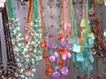Unique summer shell jewelry supplied wholesale to retail shops. Fun shaped bead and shell necklace in a variety of colors going from small to medium size as it descends down collar