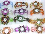Import glamour watch agent sells fashion jewelry to retail store. Fashion enamel frame in star, butterfly and flower design holds watch clock. Band created from colored beads