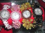 Girls fancy jewelry store wholesales watch products and gifts. Beautiful beaded, elastic stringed watch has circular clock framed by small colored beads