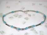 Wholesale fashion home jewelry page for international distributors. Silver necklace with solid pole chain attached with light blue beads. Center of necklace has three long silver designed beads interconnected with light blue beads