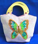 Wholesale handbag supplier selling lady fashion. Pink canvas fabric with sequins wooden handle handbag motif butterfly feature in sparkle chips and thread work design with zipper closure and inner zipper pocket