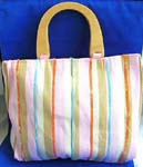 Wholesale classy purse and womens accessory supplied  online from export dealer. Fabric pink wooden handle hand bag with orange, green, blue and nature color line section and yellow sparkle chips thread work design, also inside zipper pocket, cell phone pocket and zipper closure 