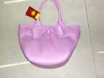 Fashion Distribution business supplying wholesale fashion accessories at discount prices. Light purple imitation leather handbag with double handles and fashion bow.