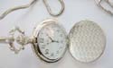 fashion pocket watch design in silver color motif floral garden pattern on cover and white clock face design
