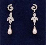 Import Jewelry distribution company supplying jewelry fashions. Spiral studs holding a cz stone embedded flower that extends into imitation pearls