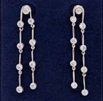 Wholesale crystal jewelry online gift shop wholesales earrings to retailers. Dangling earings with four cz stones on each of the two chains made of rhodium plated rods and one more cz stone in the stud.