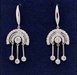 Costume jewelry wholesale distributor supplies cz earrings. Rainbow design rhodium plated earings with three cz stones hanging below and another placed in the center. 