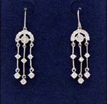 Trendy jewelry business supply store distributes wholesale jewelry. Dangly earings that begin with cz stone centered in arched top with three rhodium plated poles holding two cz chrystals on each