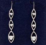 Import agents supply wholesale cz earrings online to gift stores. Cz stone set in each of the three tiered oval hoops of rhodium plated earings. 