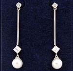 Jewelry merchant wholesaler supply dealer sells cz earring online. Long rhodium pole earings holding diamond shaped cz stone with imitation pearl below. 