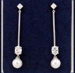 Discount jewelry design supplier sells wholesale earring fashions. Imitation pearl hanging from oval shaped cz stone that is held by rhodium pleated poles with cz chrystal studs.