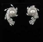 Gemtone wholesale direct supplies jewelry gifts online. Imitation pearl surrounded by spiral shaped rhodium plated base with small offshooting leaves.
