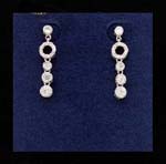 Discount  womens fashion jewelry wholesaler imports crystal earrings. Delicate earings with three cz stones that hang from small rhodium plated hoop