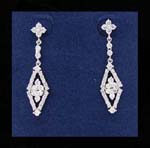 Rhinestone jewelry distributor supplying designer inspired earrings. Diamond shaped earings inlaid with cz stones has flower design in center and rhodium plated chain holding two cz chrystals.