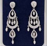 Cubic Zirconia wholesale jewelry export company supplies womens fashions. Gypsy styled earings with three levels of rhodium plated ovals and cz stones hanging within