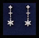 Flower jewelry supplied wholesale from import manufacturers. Cz embedded daisy held by two small rhodium plated flowers.