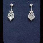 Fashion gem jewelry wholesaler imports cz earrings from China. Stylish diamond shaped cz studs holding leaf pattern and heart made with cz stones.