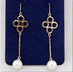 Import distributor supplies wholesale jewelry products from China. Four faux gold plated circles in diamond shape suspend chain with imitation pearl attached at bottom