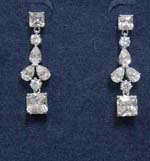 China export jewelry manufacturer supplied wholesale crystal earrings. Square cz stone hang below rhodium plated chain with cz chrystals set in each of the five oval shapes suspended from another square cz stone. 