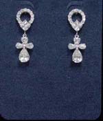 Distribution company supplies womens designer jewelry at wholesale price. Angel figure made from four cz stones are hanging from circular stud embedded with cz crystals