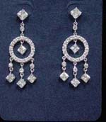 Catalog jewelry store distributes wholesale cz earring fashions. Dream catcher inspired earings have diamond shaped studs suspending cut circle inlaid with cz stones along with three cz chrystals hanging beneath and one in the center.
