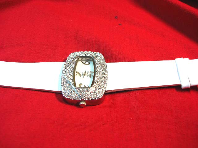 Stylish ladies white strap watch with beauty gems inlaid in large frame. Women accessory supply store