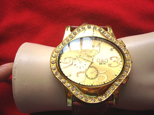 Direct G & Q contemporary oval framed watch in gold with large numbers and burgundy imitation leather strap warehouse