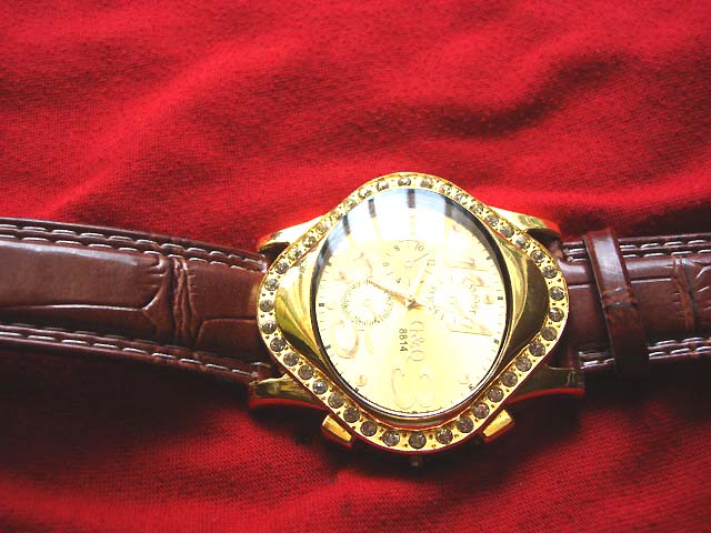 New age G & Q designed watch with gold colored oval frame and burgundy, imitation leather strap jewelry market
