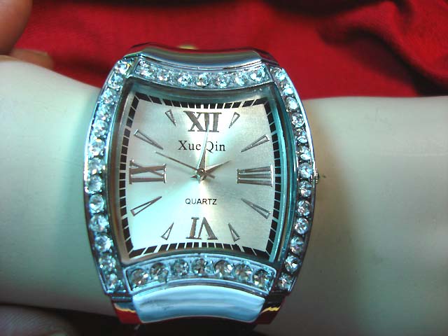 Jewelry distribution express - Dali inspired quartz clock face on silver fashion watch with cz gems along frame 