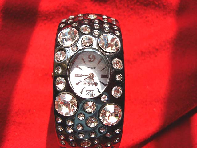 Black bangle bracelet watch with a variety of sized cz gems on strap wholesale distributor