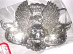 Silver belt buckle with evil head and swings design