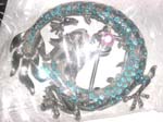 Curvy green dragon holding a pinky cz on mouth