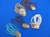 Oval or rectangle shaped sea shell in center of multi string bali bead bracelet in an assortment of colors