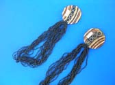 Circle design on wooden pendant dangling from beaded, multi black necklace